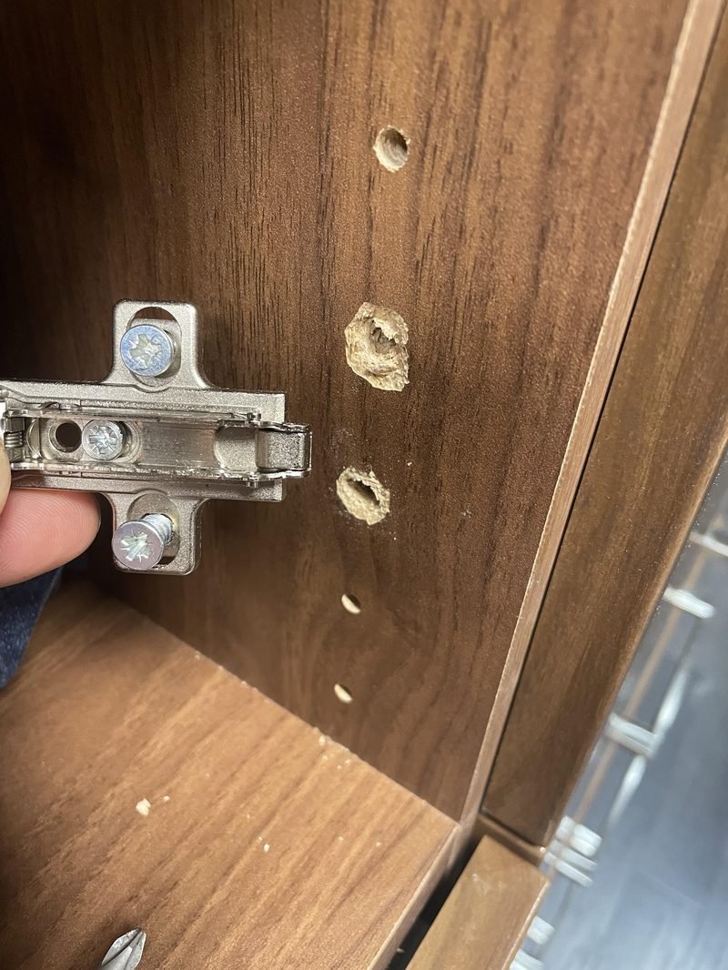 Cabinet hinge repair Singapore — damaged kitchen cabinet door hinge with stripped screw holes, cabinet repair HDB