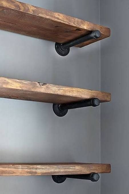 Shelf installation Singapore — rustic wooden floating shelves on wall with black iron pipe brackets, shelf installer